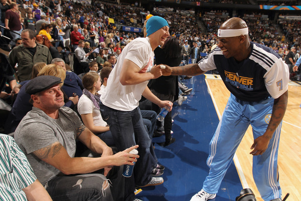 Al Harrington shares some laughs with Troy Tulowitzki and Jason Giambi of the Colorado Rockies as the Nuggets host the Los Angeles Lakers at the Pepsi Center on January 21, 2011.