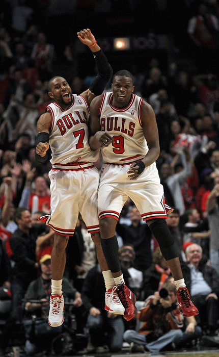 C.J. Watson #7 and Loul Deng #9 of the Chicago Bulls celebrate after Watson hit a three-point shot to tie the game in regulation against the Miami Heat.