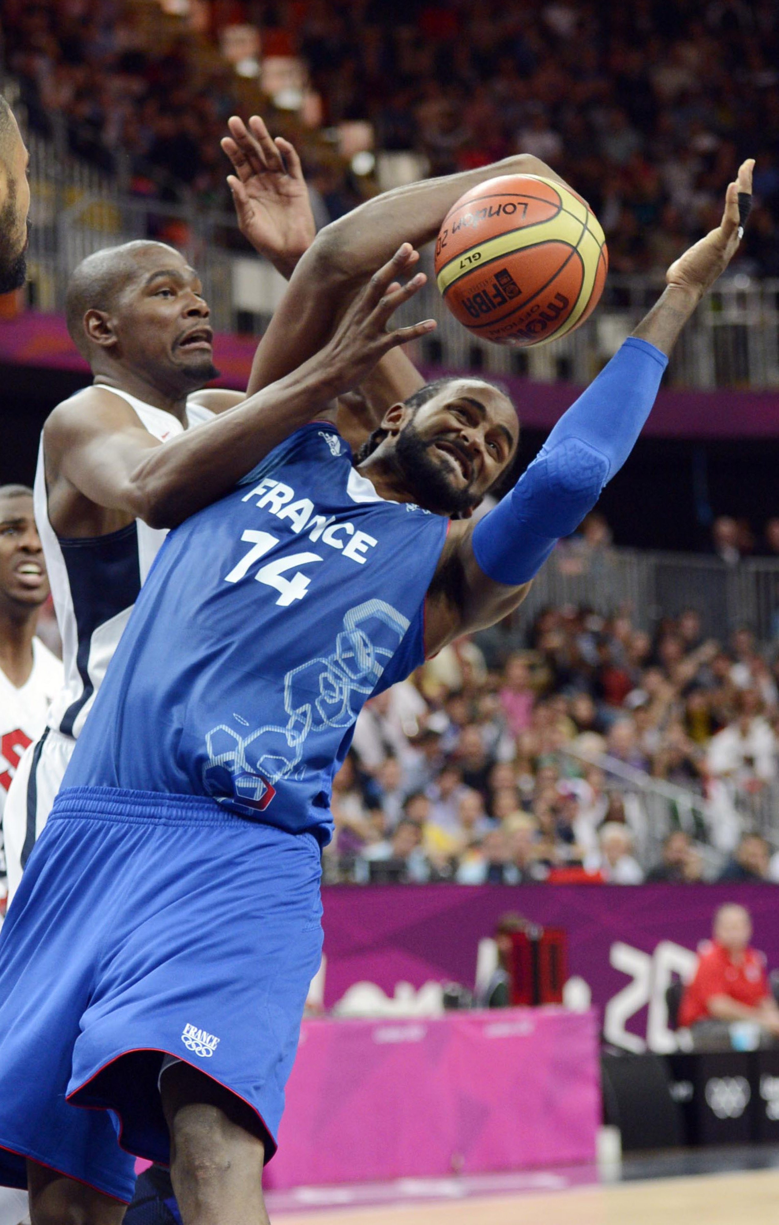 France center Ronny Turiaf (14) battles for the ball with USA's Kevin Durant.