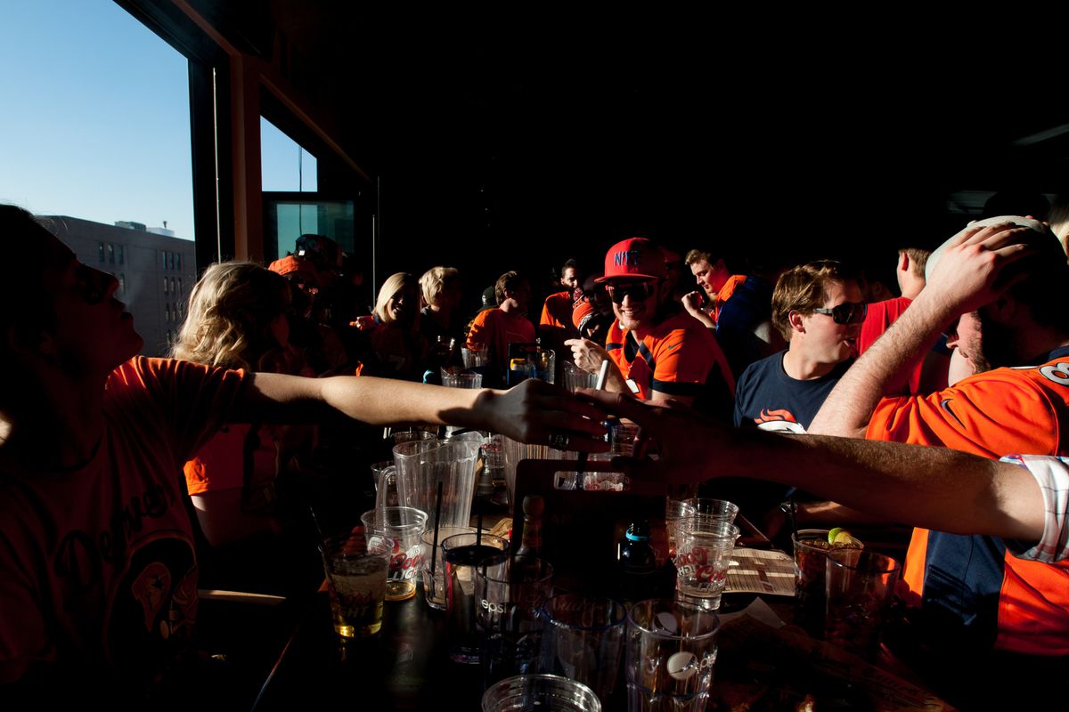 Colorado sports fans pass a vaporizer around pre-Super Bowl.
