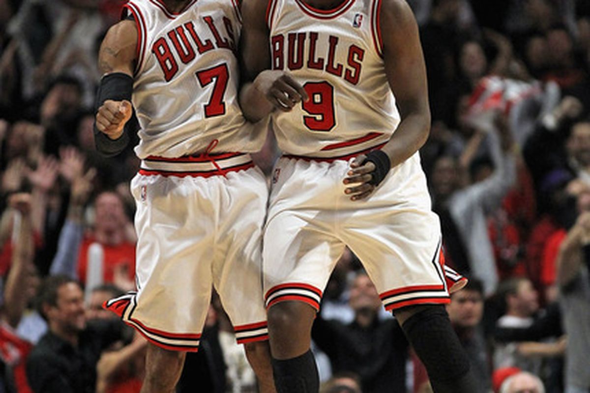 C.J. Watson #7 and Loul Deng #9 of the Chicago Bulls celebrate after Watson hit a three-point shot to tie the game in regulation against the Miami Heat.