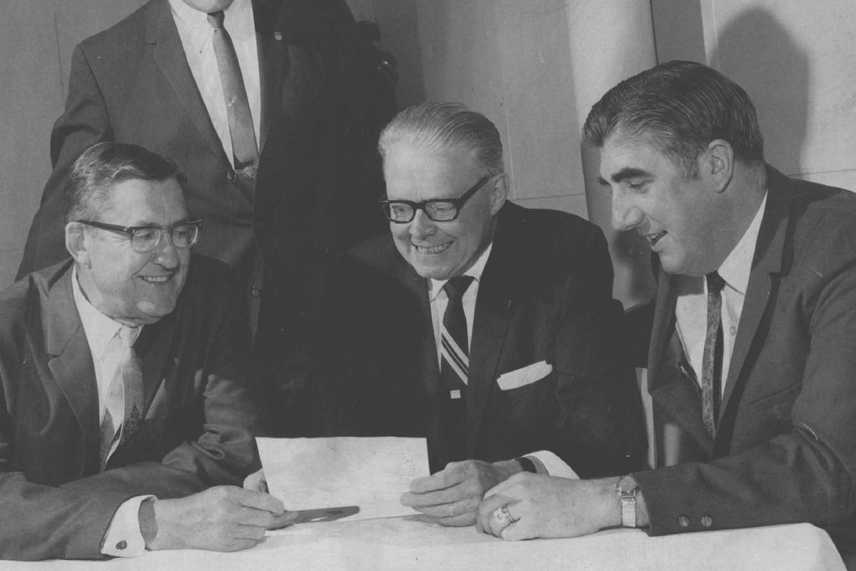 MAY 6 1969; Dwight Johnson, standing, chairman of the Denver Rockets 1969-70 season-ticket drive watches as Mayor Bill McNichols, center, owner J. W. (Bill) Ringsby, left, and Vince Boryla hold a season-ticket.