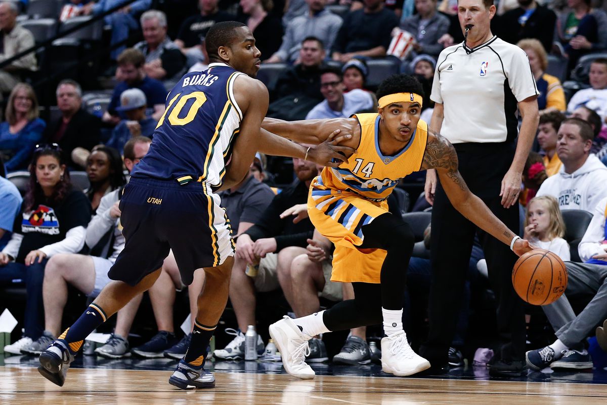 Gary Harris drives past Alec Burks.