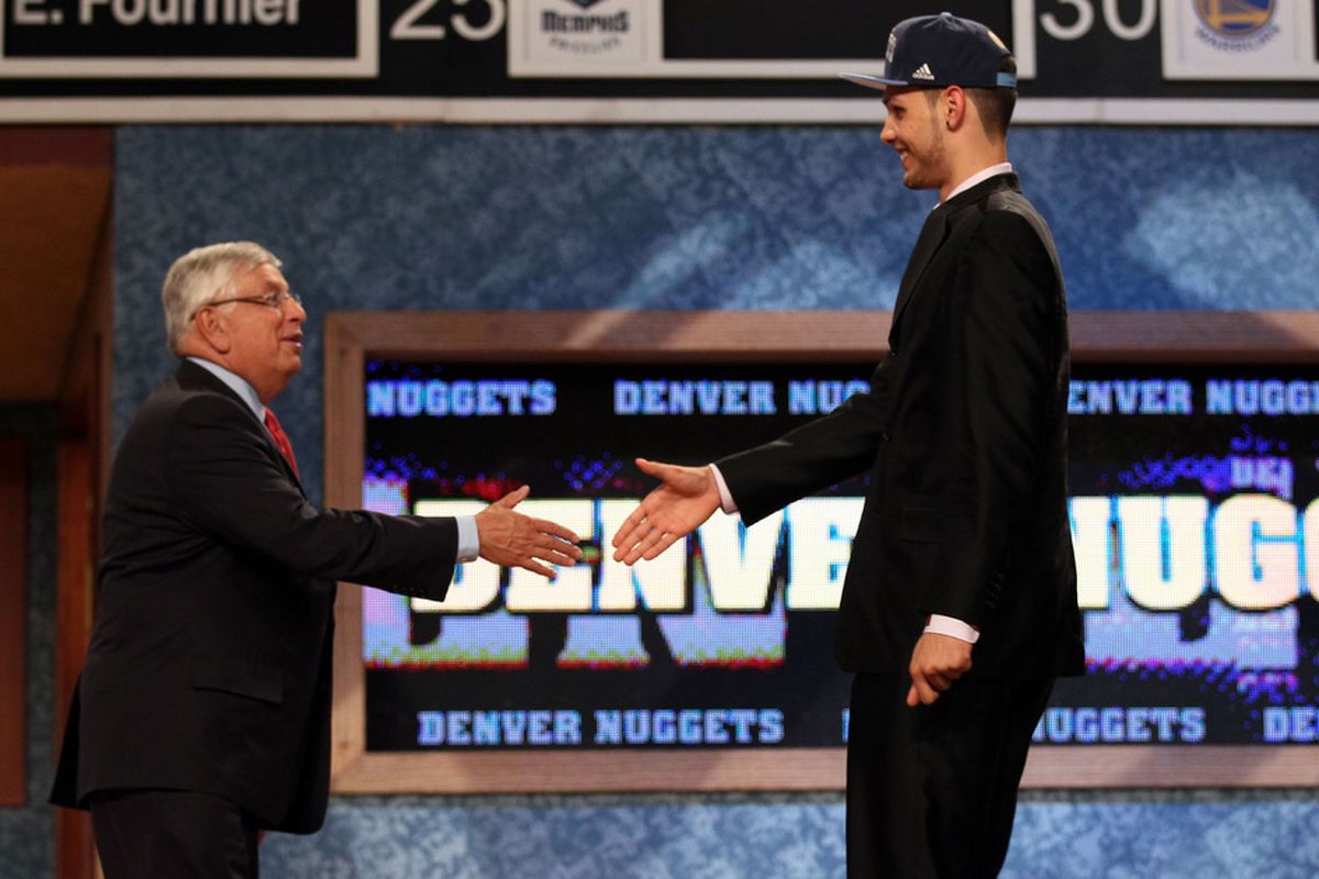 Evan Fournier from France greets NBA Commissioner David Stern after he was selected number twenty overall by the Denver Nuggets.