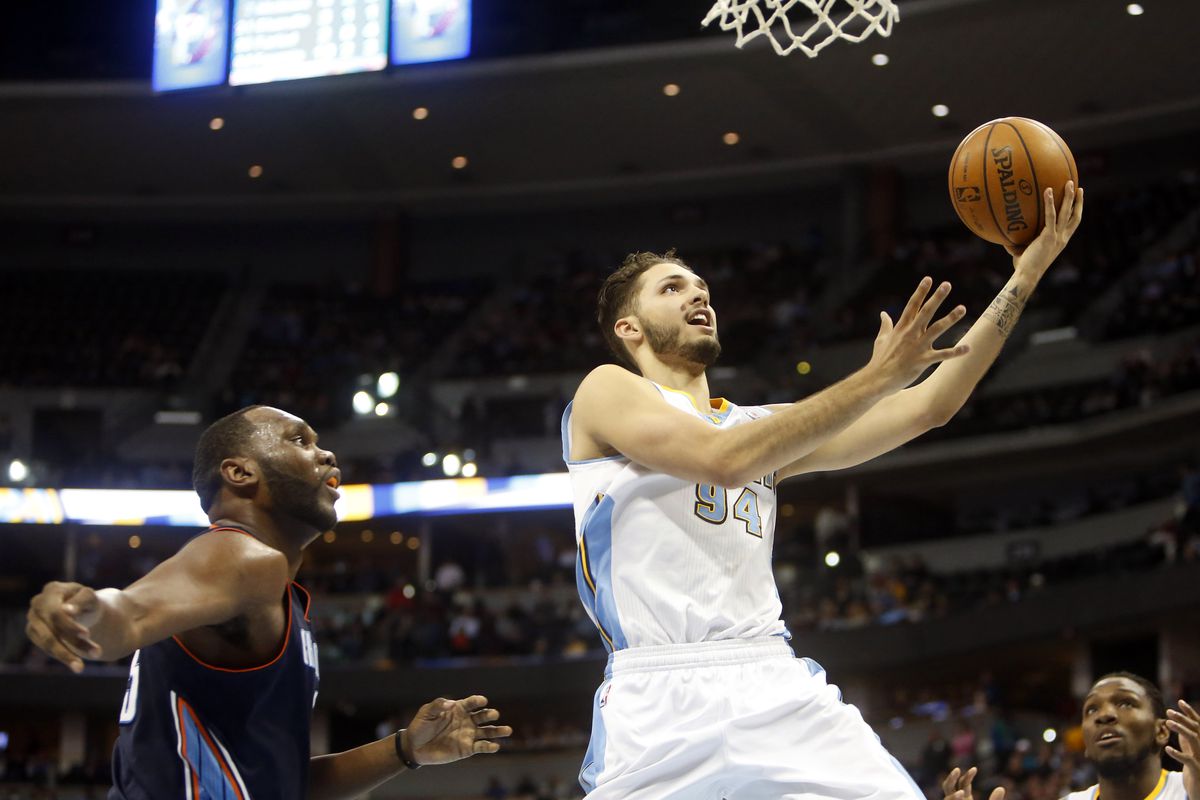 Evan Fournier drives past Al Jefferson