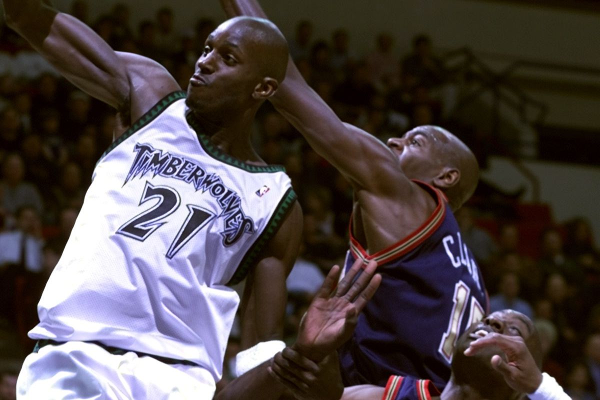 Minneapolis Mn, Timberwolves vs Denver Nuggets. — Timberwolves Kevin Garnett pulls down a defensive reboound over Denver’s Keon Clark during 2nd period NBA action at the Target Center.